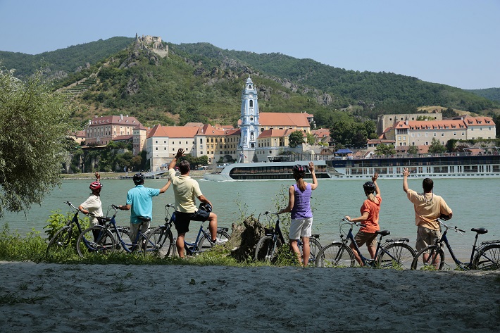Family admiring the Danube on a bicycle excursion during an AmaWaterways cruise