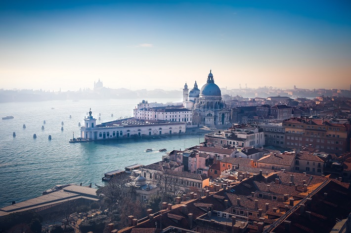 The hazy skyline of historic buildings and churches in Venice