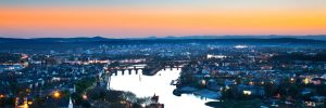The Rhine winding through Koblenz as the sun sets at night