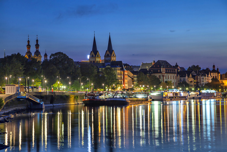Boats lining the Rhine River in Koblenz at night