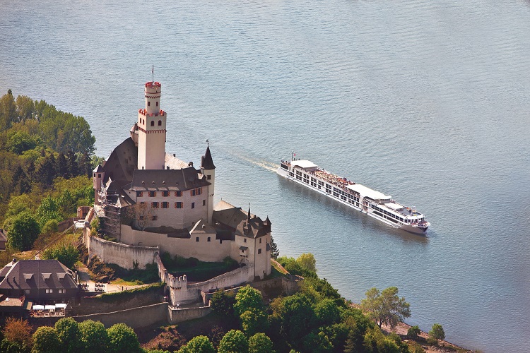 The Uniworld river cruise ship SS Antoinette sailing past a castle on the Rhine